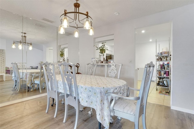 516 Fort Smith Blvd, Deltona, FL 32738 - dining room featuring wood finished floors, a textured ceiling, and a chandelier