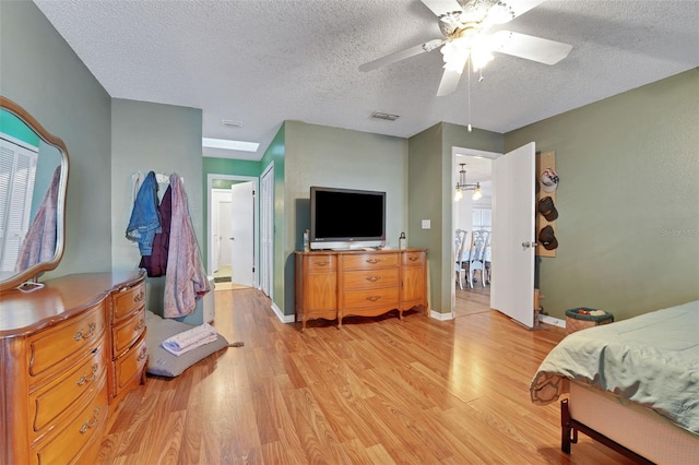 516 Fort Smith Blvd, Deltona, FL 32738 - bedroom with light wood-type flooring, a textured ceiling, and ceiling fan