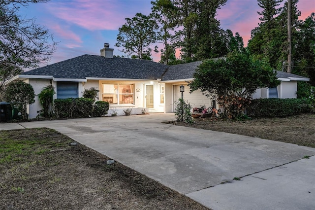 516 Fort Smith Blvd, Deltona, FL 32738 - ranch-style home with stucco siding, driveway, a chimney, and a shingled roof