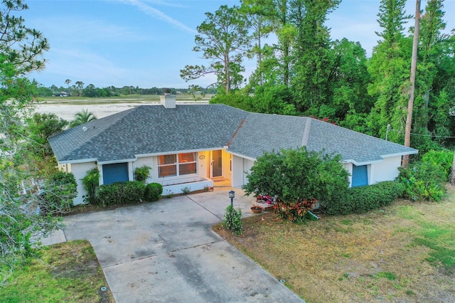 516 Fort Smith Blvd, Deltona, FL 32738 - single story home with concrete driveway, stucco siding, roof with shingles, and a chimney