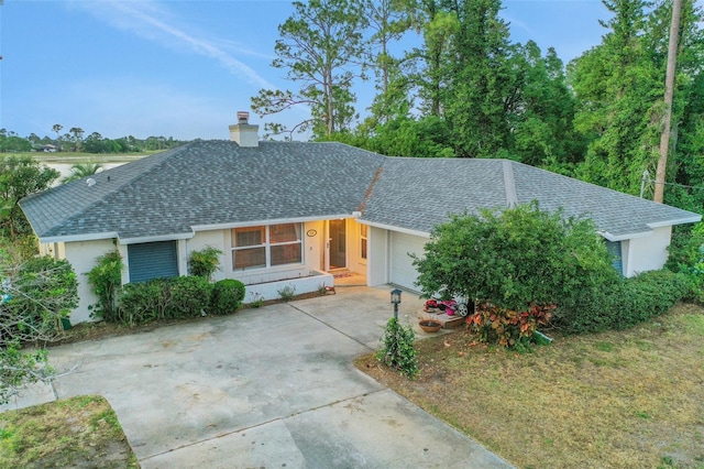 516 Fort Smith Blvd, Deltona, FL 32738 - ranch-style house with a shingled roof, a garage, a chimney, and stucco siding