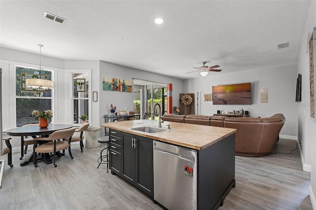 4027 Lakeside Reserve Ct, Orlando, FL 32810 - kitchen with wooden counters, a sink, a textured ceiling, visible vents, and dishwasher