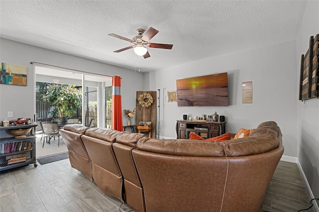 4027 Lakeside Reserve Ct, Orlando, FL 32810 - living area featuring a textured ceiling, light wood-style flooring, and a ceiling fan