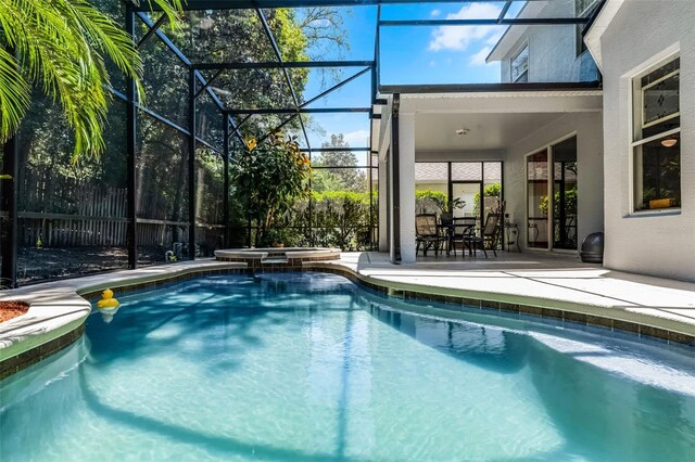 4027 Lakeside Reserve Ct, Orlando, FL 32810 - view of swimming pool with a patio, a pool with connected hot tub, and glass enclosure