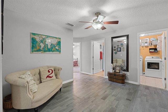 4027 Lakeside Reserve Ct, Orlando, FL 32810 - interior space featuring wood finished floors, a textured ceiling, visible vents, washer and dryer, and a ceiling fan
