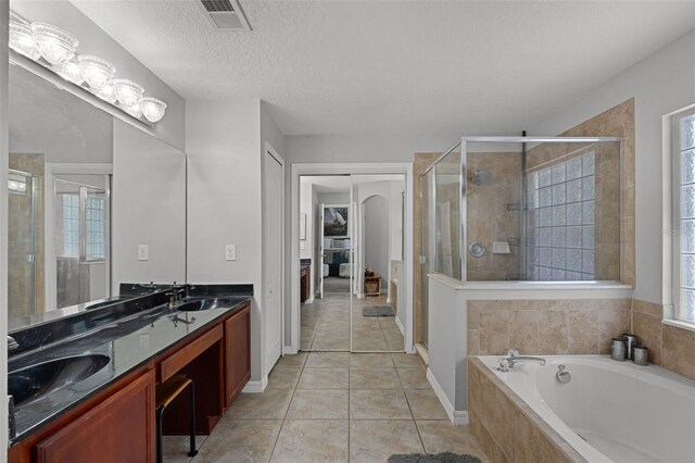 4027 Lakeside Reserve Ct, Orlando, FL 32810 - bathroom with a stall shower, tile patterned flooring, a sink, and visible vents