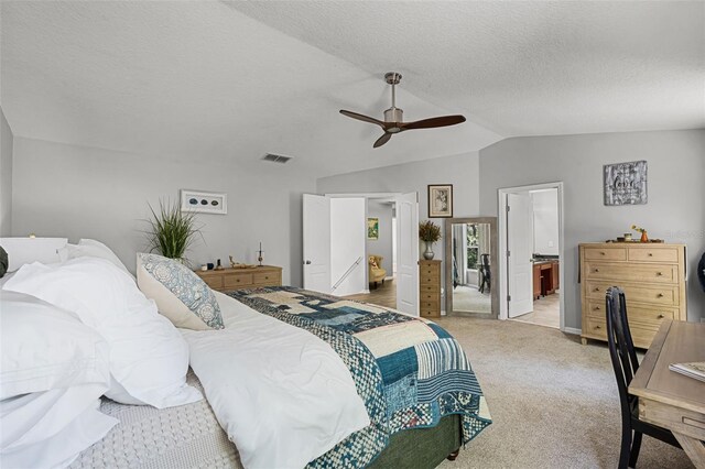 4027 Lakeside Reserve Ct, Orlando, FL 32810 - bedroom with lofted ceiling, a textured ceiling, visible vents, connected bathroom, and light carpet