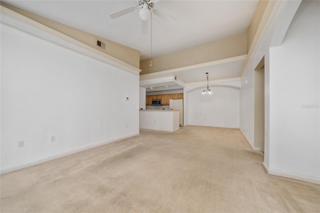 unfurnished living room featuring ceiling fan, baseboards, visible vents, and light carpet