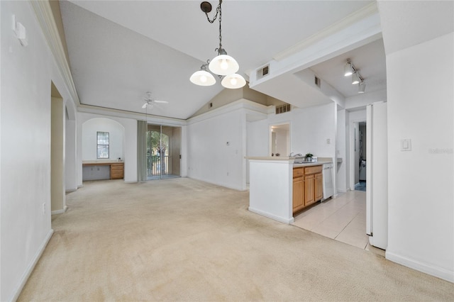 kitchen featuring ceiling fan, pendant lighting, arched walkways, dishwasher, and light colored carpet