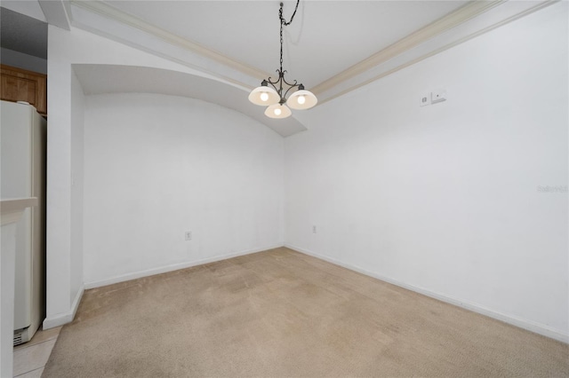spare room featuring crown molding, an inviting chandelier, light colored carpet, and baseboards