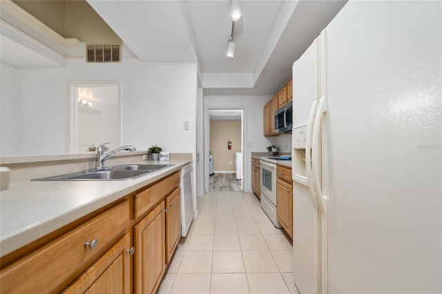 kitchen with a sink, light tile patterned floors, white appliances, visible vents, and light countertops