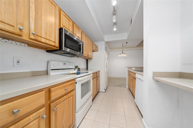 kitchen featuring track lighting, white appliances, hanging light fixtures, light tile patterned floors, and light countertops