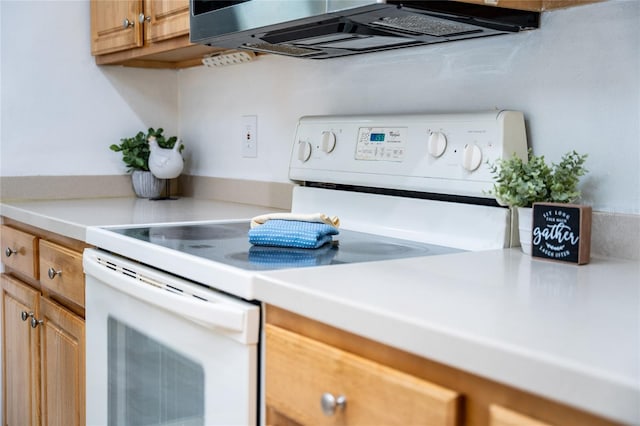 kitchen featuring light countertops and white electric stove