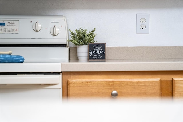 details featuring light countertops and range with electric stovetop