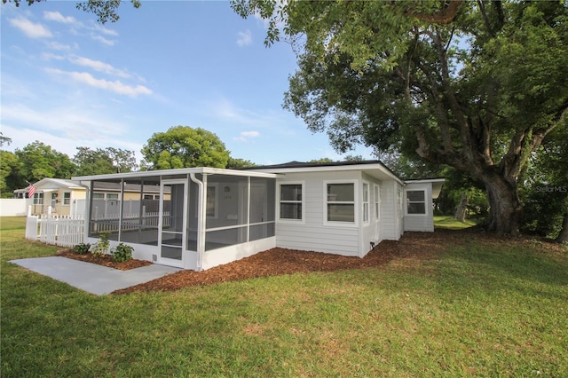 1016 E Fillmore Ave, Orlando, FL 32809 - back of property with a sunroom and a yard