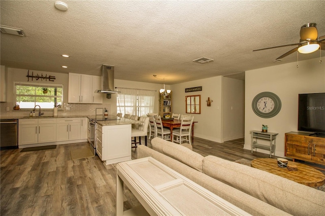 1529 Glastonberry Rd, Maitland, FL 32751 - living area featuring dark wood-type flooring, a ceiling fan, a textured ceiling, a chandelier, and recessed lighting