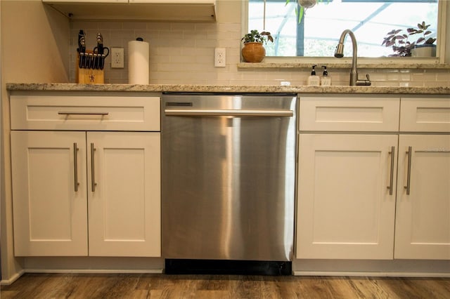 1529 Glastonberry Rd, Maitland, FL 32751 - kitchen with dishwasher, white cabinetry, and decorative backsplash