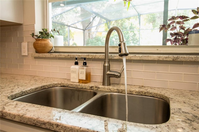1529 Glastonberry Rd, Maitland, FL 32751 - kitchen view of a sink, tasteful backsplash, and light stone counters