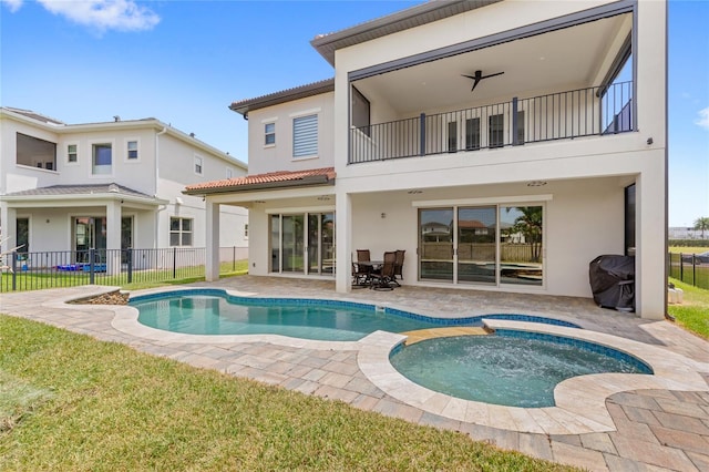 rear view of property featuring a patio, stucco siding, a balcony, and fence
