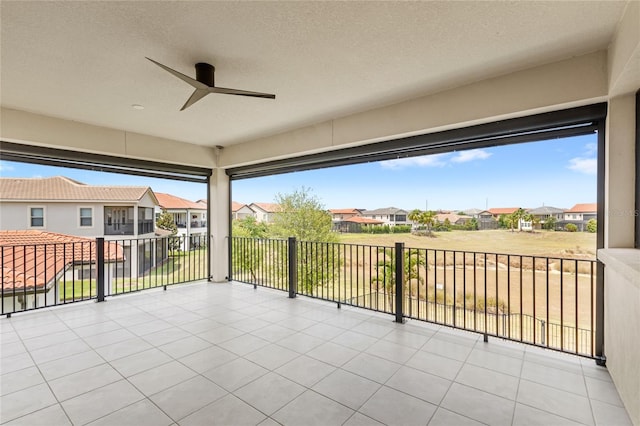 view of patio / terrace with a residential view and a ceiling fan
