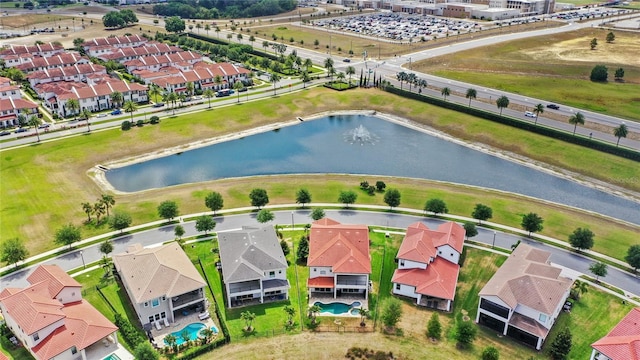 drone / aerial view featuring a water view and a residential view
