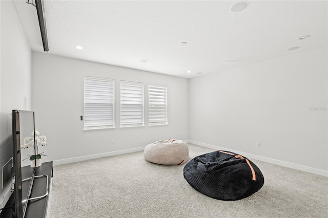 living area featuring recessed lighting, baseboards, and carpet
