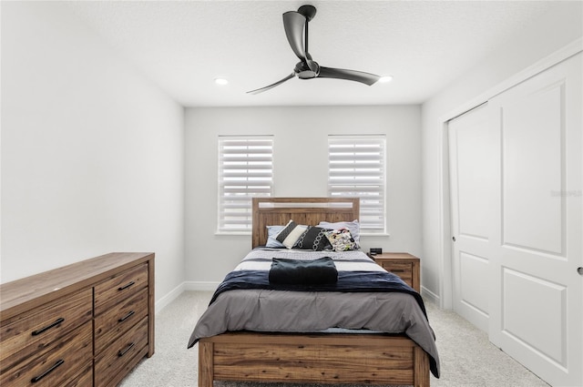 bedroom with light colored carpet, a ceiling fan, baseboards, and recessed lighting