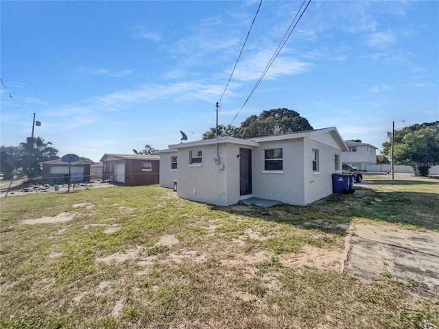 back of house with fence and a yard