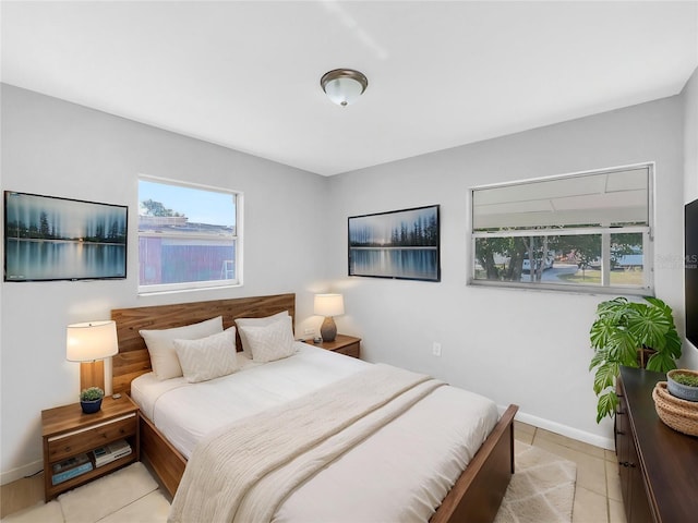 bedroom with baseboards and light tile patterned floors