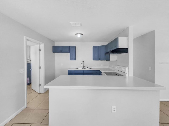 kitchen featuring blue cabinets, light tile patterned floors, electric range, under cabinet range hood, and a sink