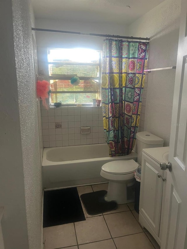 full bath featuring a textured wall, tile patterned flooring, vanity, toilet, and shower / tub combo