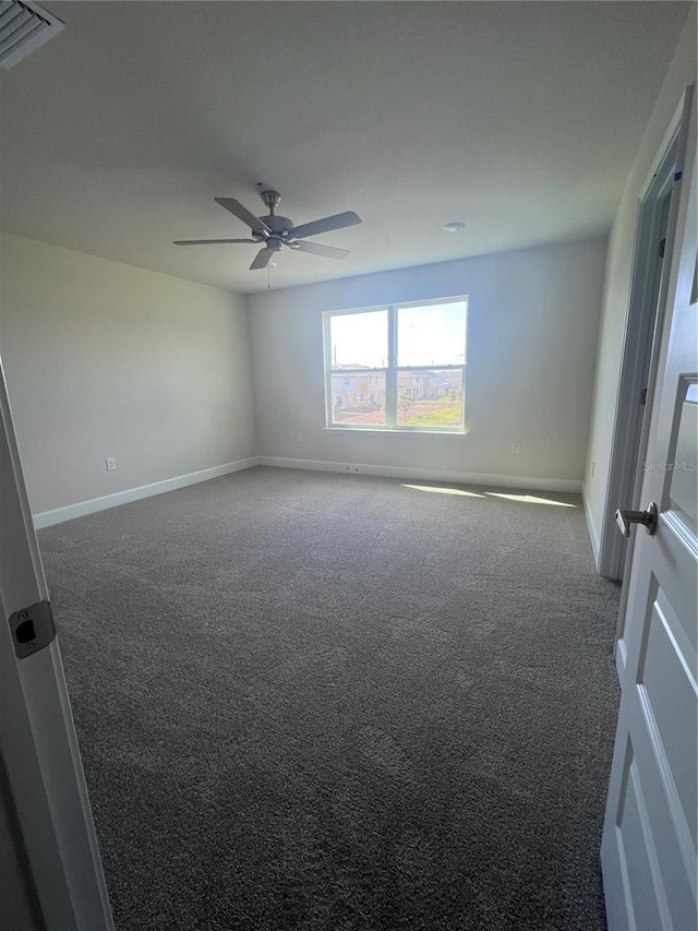 unfurnished room featuring carpet floors, baseboards, and ceiling fan