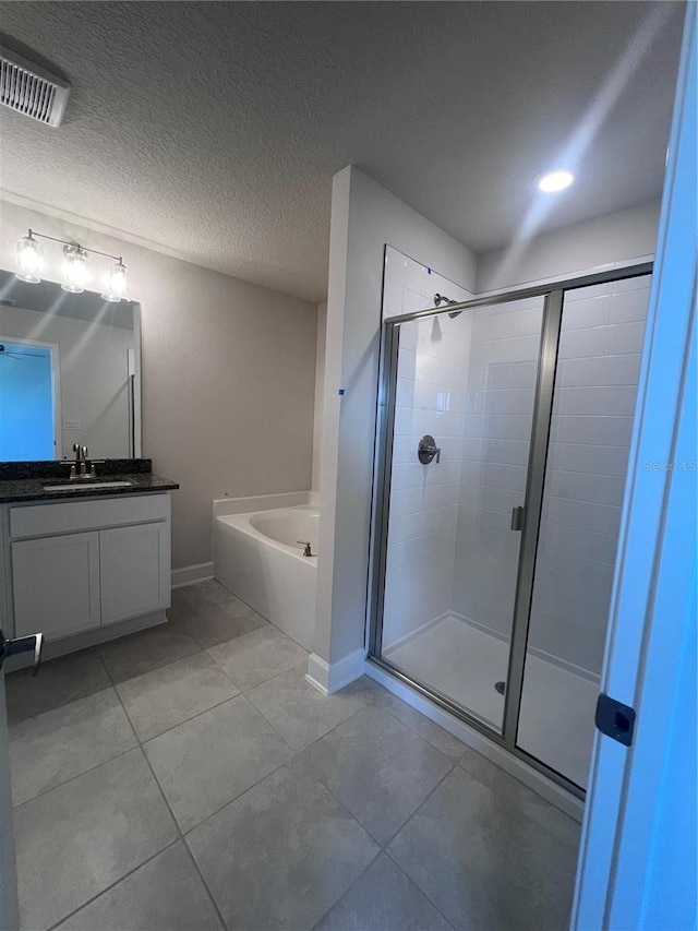 bathroom with visible vents, a stall shower, a bath, and vanity
