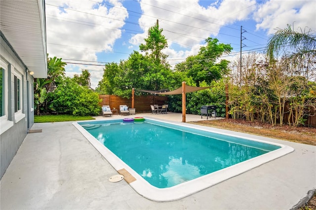 pool featuring a fenced backyard and a patio area