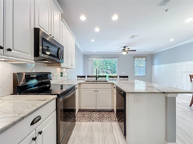 kitchen with a sink, black dishwasher, a peninsula, ornamental molding, and electric range
