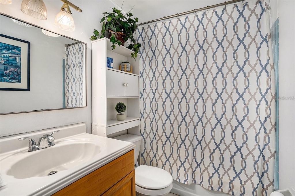 bathroom featuring vanity and toilet
