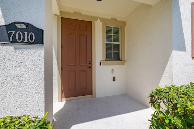 doorway to property with stucco siding
