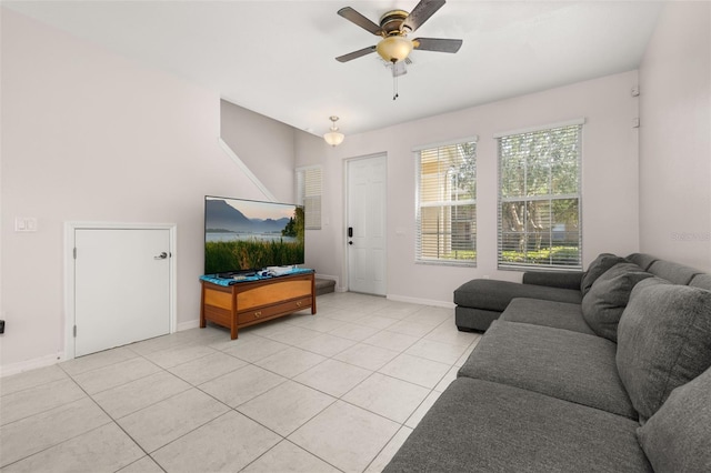 living room featuring light tile patterned flooring, a ceiling fan, and baseboards