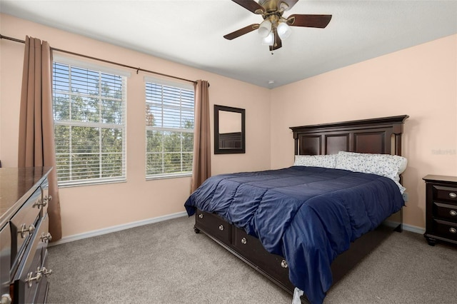 bedroom featuring light colored carpet, ceiling fan, and baseboards