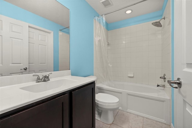 bathroom featuring visible vents, toilet, shower / bath combination with curtain, vanity, and tile patterned flooring