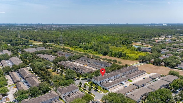bird's eye view featuring a wooded view and a residential view