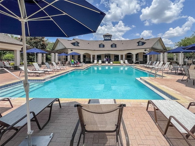 pool with a gazebo and a patio