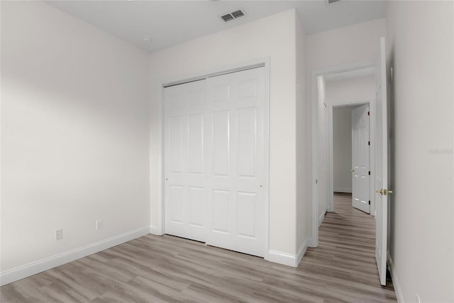 850 Spring Oak Cir, Orlando, FL 32828 - unfurnished bedroom with light wood-type flooring, baseboards, and a closet