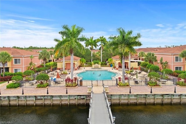 20310 Estero Gardens Cir Unit 203, Estero, FL 33928 - view of pool featuring a water view and a patio