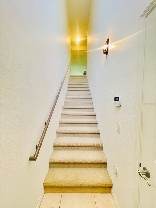 20310 Estero Gardens Cir Unit 203, Estero, FL 33928 - staircase featuring tile patterned floors and baseboards