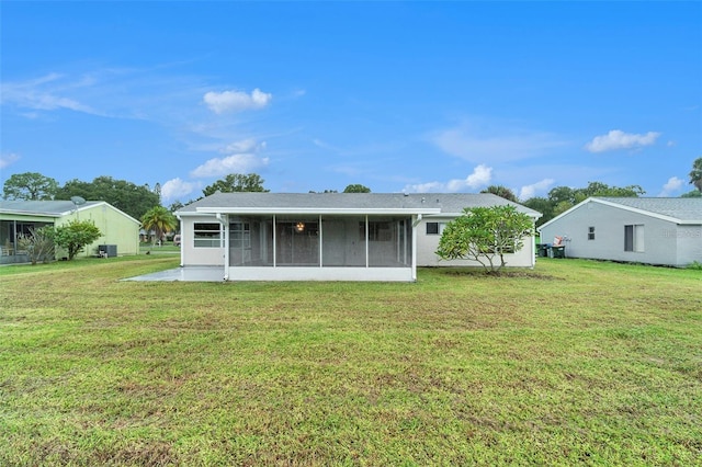 5052 Trekell St, North Port, FL 34287 - back of house with a lawn and a sunroom