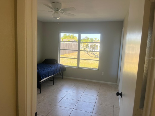 5052 Trekell St, North Port, FL 34287 - bedroom featuring baseboards, ceiling fan, and light tile patterned floors