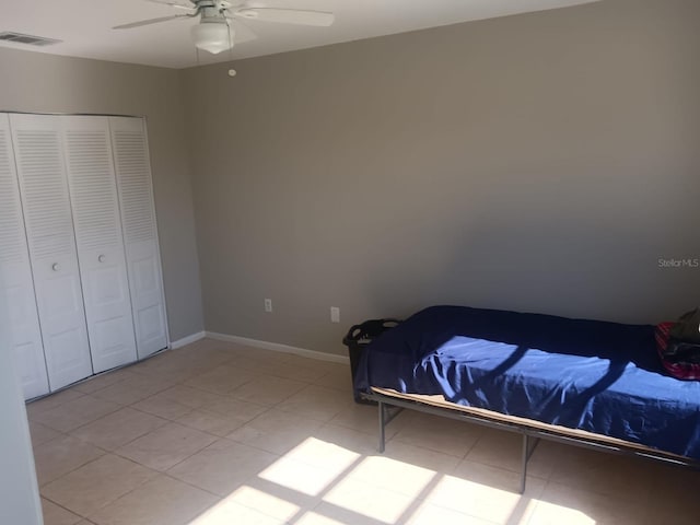 5052 Trekell St, North Port, FL 34287 - bedroom featuring visible vents, a closet, baseboards, a ceiling fan, and light tile patterned floors