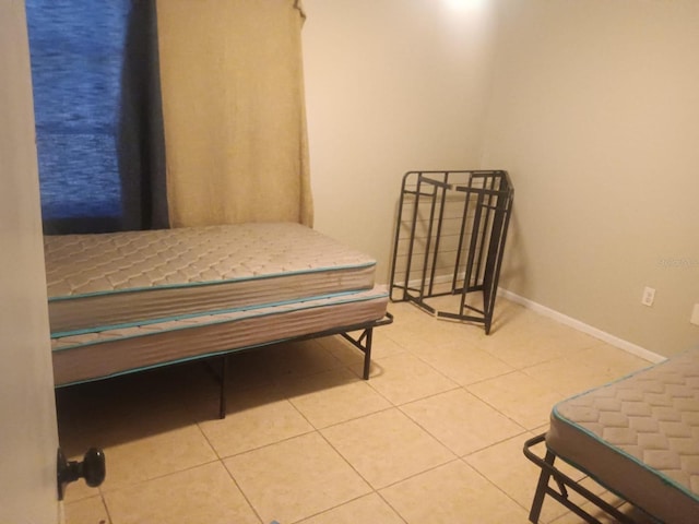 5052 Trekell St, North Port, FL 34287 - tiled bedroom with baseboards