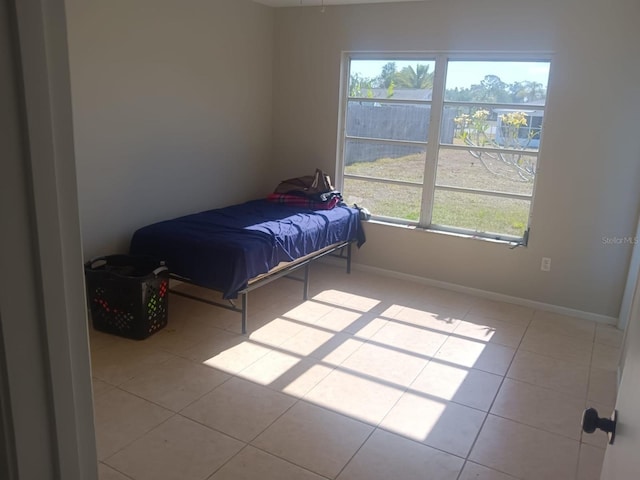 5052 Trekell St, North Port, FL 34287 - bedroom featuring baseboards and tile patterned flooring